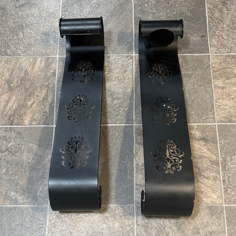 black metal wall sconces or scroll decor pieces,